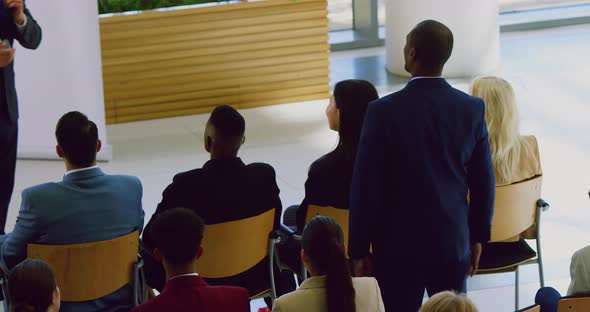 Businessman raising her hand in a business seminar 4k