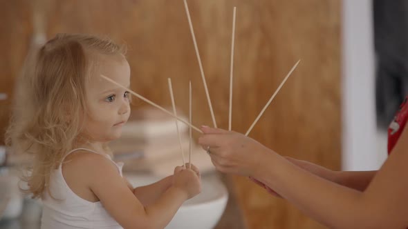 Woman Is Teaching Cute Little Girl Counting at Home.