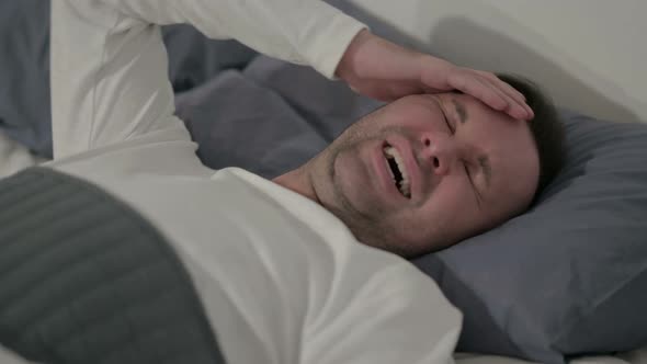 Close Up Casual Man Having Headache While Sleeping in Bed