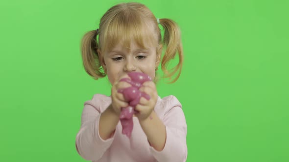 Kid Playing with Hand Made Toy Slime. Child Having Fun Making Pink Slime