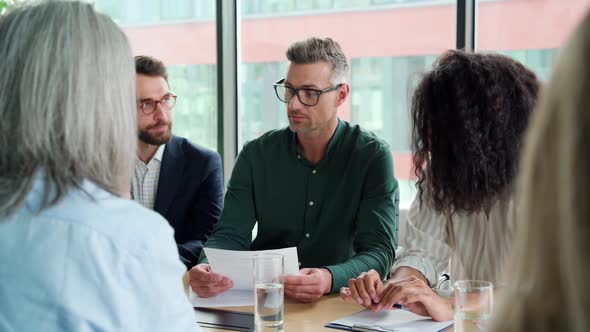 Businessman Handshaking Partner at Group Meeting Making Business Agreement