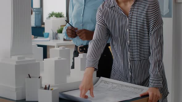 Close Up of Diverse Team of Women Working on Blueprints Design on Table