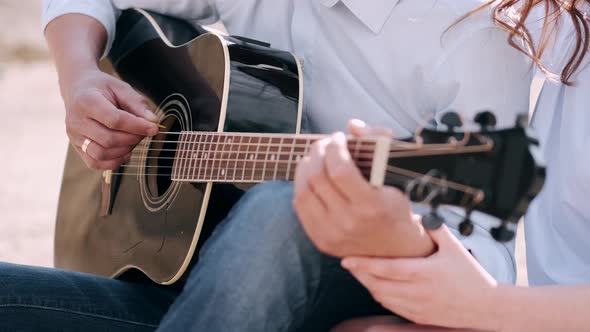 Cropped View of Male Hands Playing Song Outside