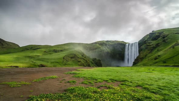 Morning Light over Waterfall Skogafoss in Green Icelandic Nature