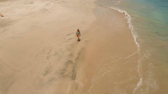 Girl Walking on the Beach. Bali, Indonesia