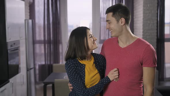 Happy Young Adults Couple Shaking New House Keys