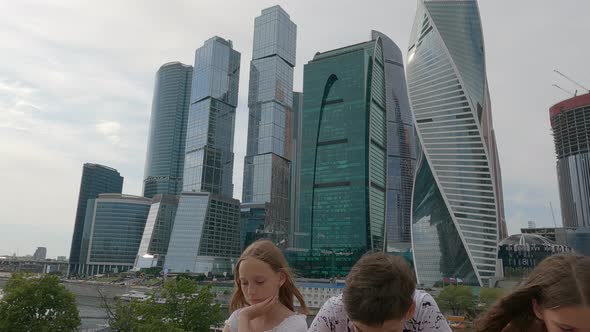 Modern Urban Teenagers Using Mobile Phones on Business Skyscrapers Background