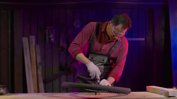 Mechanic Repairing a Bicycle Wheel in a Garage