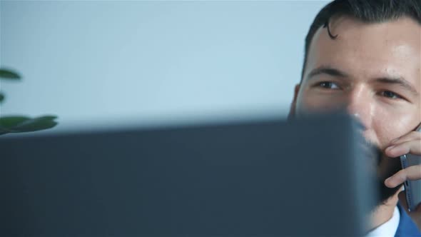 Young Bearded Businessman Talking On Phone