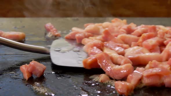 Closeup of Minced Bacon Roasting and Sizzling on the Grill Surface