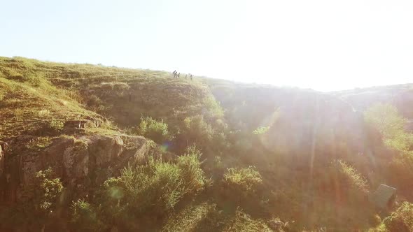 Tourists Exploring Near Camping in Rocky Prairie Landscape