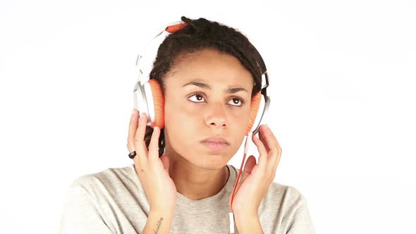 Sad Young Woman Listening Music with Headphones