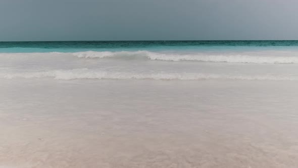 Landscape of Beautiful Tropical Beach with Tidal Waves and Blue Sky Zanzibar