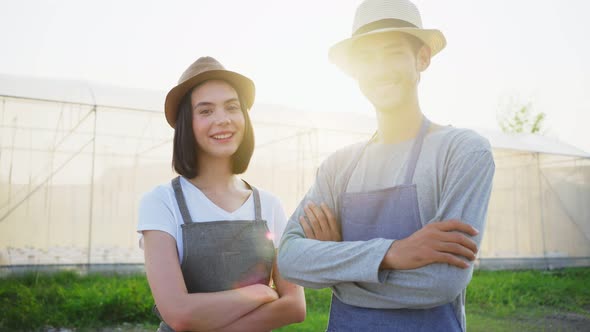 Portrait of Asian couple farmers owner working in vegetables hydroponic farm with happiness.