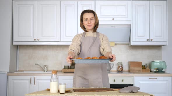 Young Woman Cooking Food On Kitchen At Home. Baking Fresh Croissants.