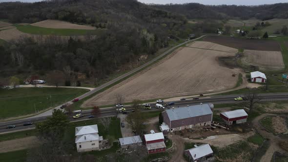 aerial view of accident scene in front of a farm on a rural highway on a rainy day.