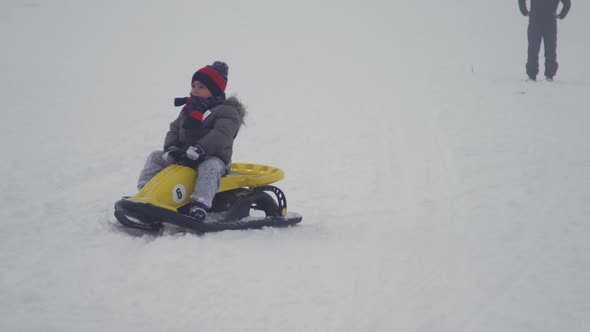 The boy is skiing in the snow.