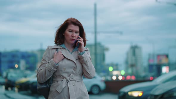 Business Woman Talking on Phone Against Parking Lot