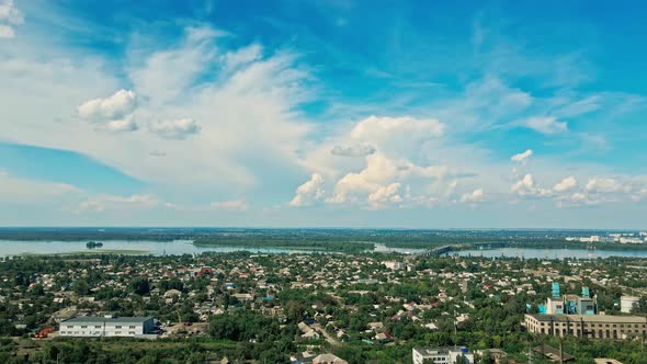 Aerial Landscape with Green City Part, Big River and Beautiful Blue Sky with White Clouds.