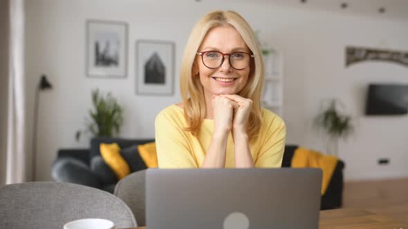 Charming Senior Elderly Woman Spends Leisure Time in Networks on the Computer