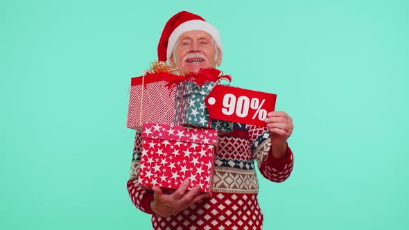 Senior Man in Christmas Sweater Showing Gift Box and 90 Percent Discount Inscriptions Banner Text