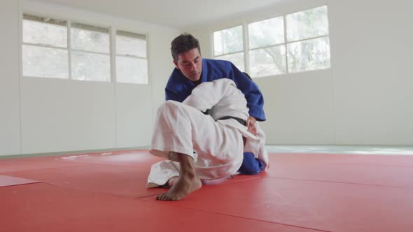 Judokas fighting and immobilizing on the ground