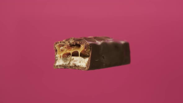 Bitten Chocolate Spin on Isolate Pink Background