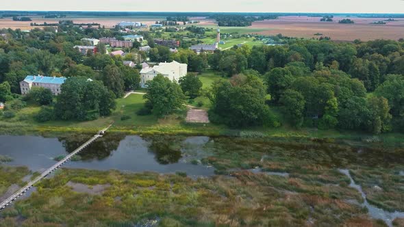 Aerial Shot City Mezotne, Latvia Republic. Mezotne Palace and Park With Fountain. Lielupe River With