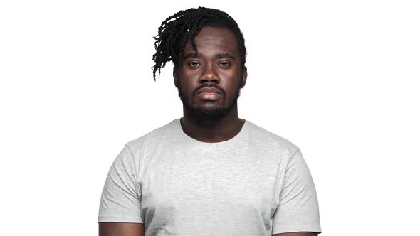 Portrait of Adult Dark Skinned Guy in Casual Tshirt Grinning at Camera and Looking with Meaningful