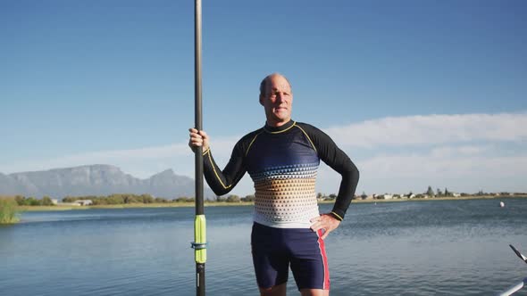 Portrait of senior caucasian man standing by a river