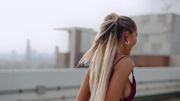 Two Fashion Models Dancing And Laughing In Clubwear On City Roof