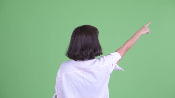 Rear View of Asian Businesswoman Pointing Finger and Directing