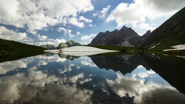 Time lapse clouds reflection in mountain lake Bavarian Alps Germany