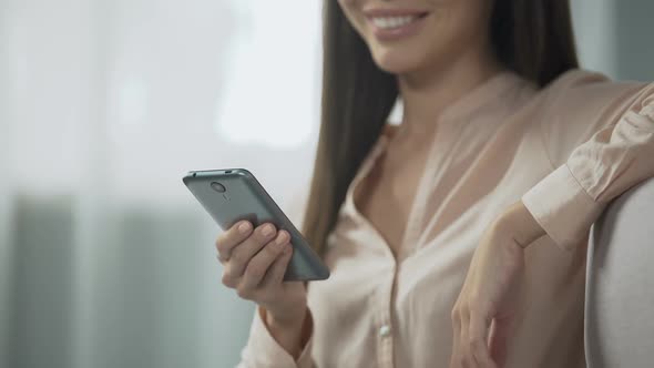 Charming Girl Booking Hotel Room With a Smartphone, User-Friendly Reserving