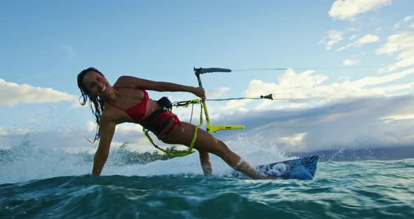 Woman Kiteboarding at Sunset