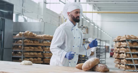 Funny Dancing Baker in a Bakery Industry While