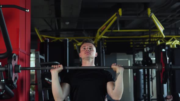 Muscular Man is Engaged in the Gym