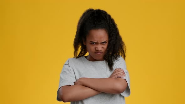 Discontented African American Teen Girl Crossing Hands Over Yellow Background