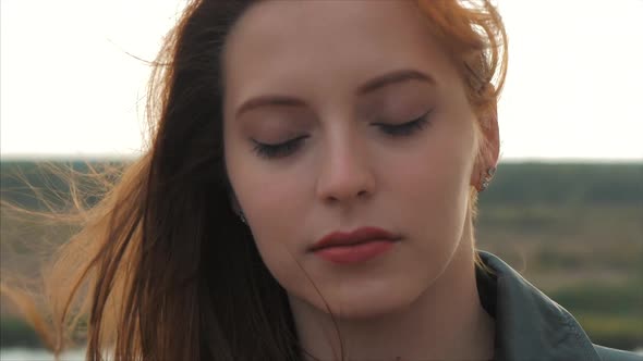 Portrait of a Petty Woman With Red Hair Standing High on a Hill, Girl the Background of Nature