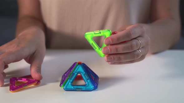 Close Up of Magnetic Building Toy. WOman Playing with Preschooler. 