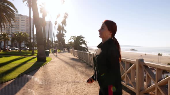 Mature Woman Exercising At The  Beach