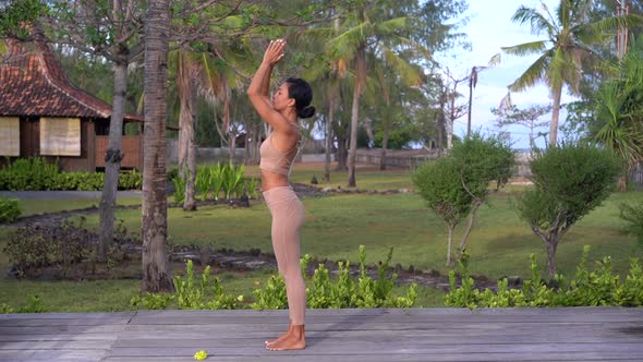 Yoga Teacher Lady Doing Sun Salutation Practise Outdoors on the Exotic Island Nature with Palm Trees