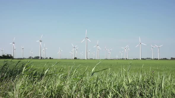 View to electric windmill and gray sky in a sunny day