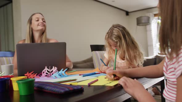 Mother and daughters painting together