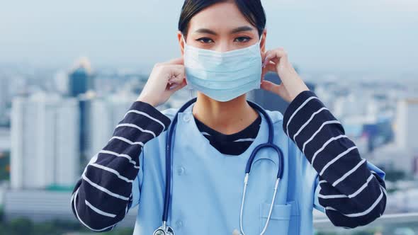 Portrait of young asian woman doctor healthcare professional in blue uniform