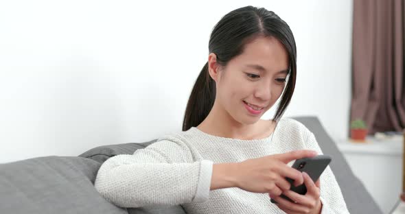 Woman use of mobile phone at home