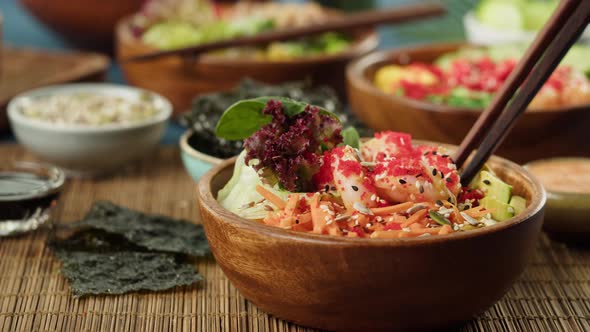 Putting Chopsticks Into Cooked Poke Bowl Closeup