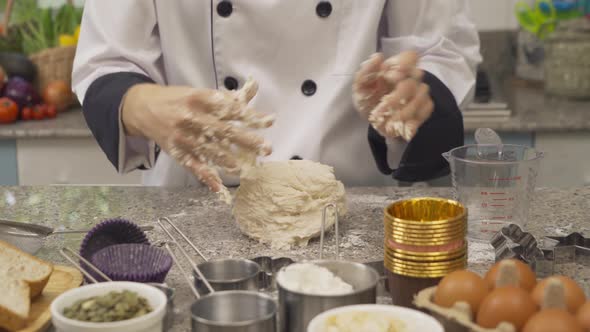 Close up of chef woman hands threshing flour in kitchen at home, homemade bakery cooking