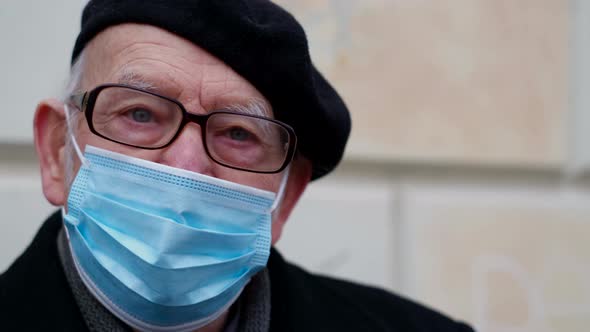 An Old Retiree in a Protective Mask Against Coronavirus