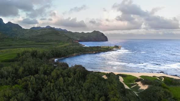 Bird's eye view of coast of a tropical island with forest, mountain and ocean in Kauai, Hawaii, USA